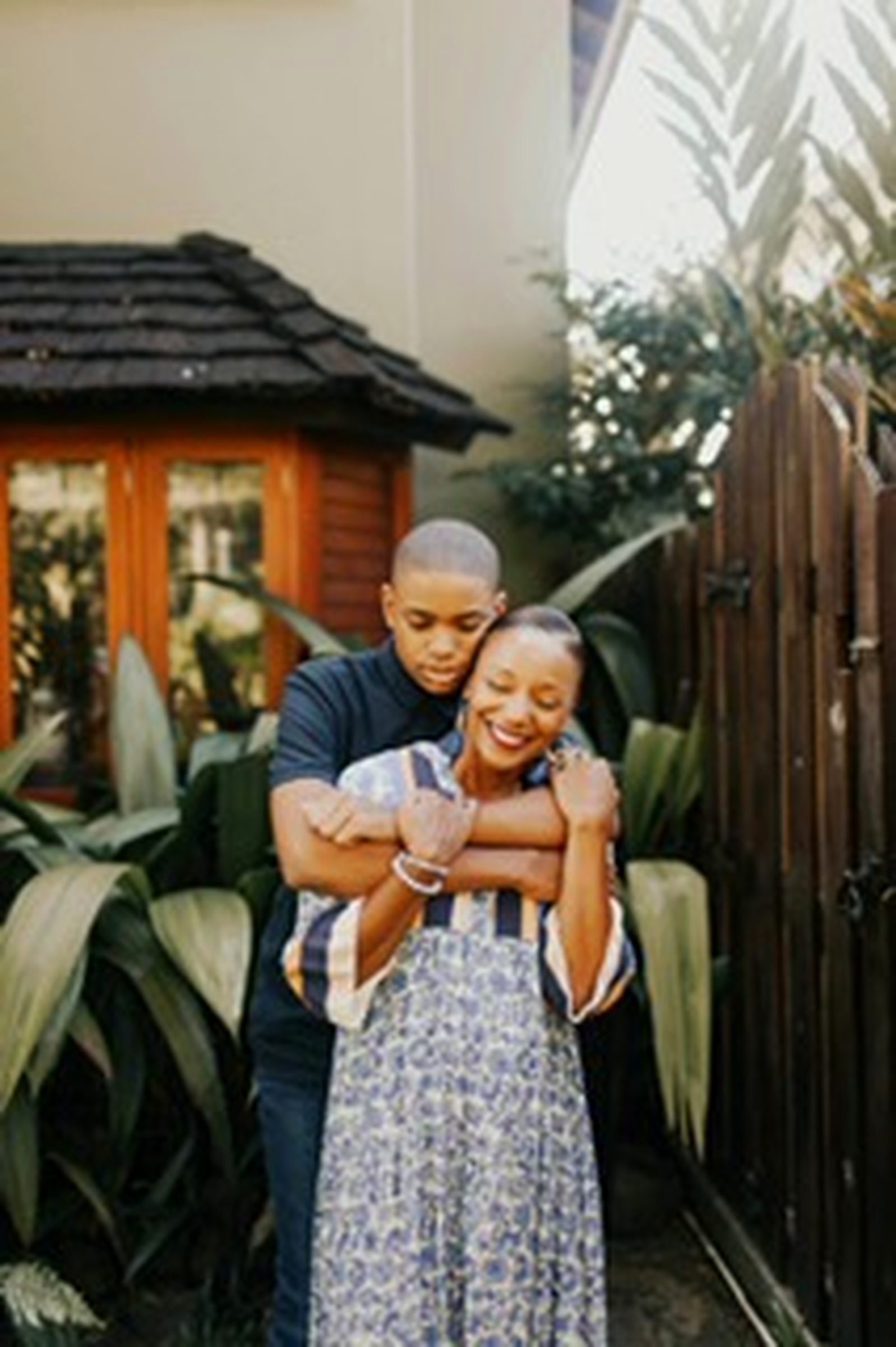 Francene Noel laughing as her son embraces her