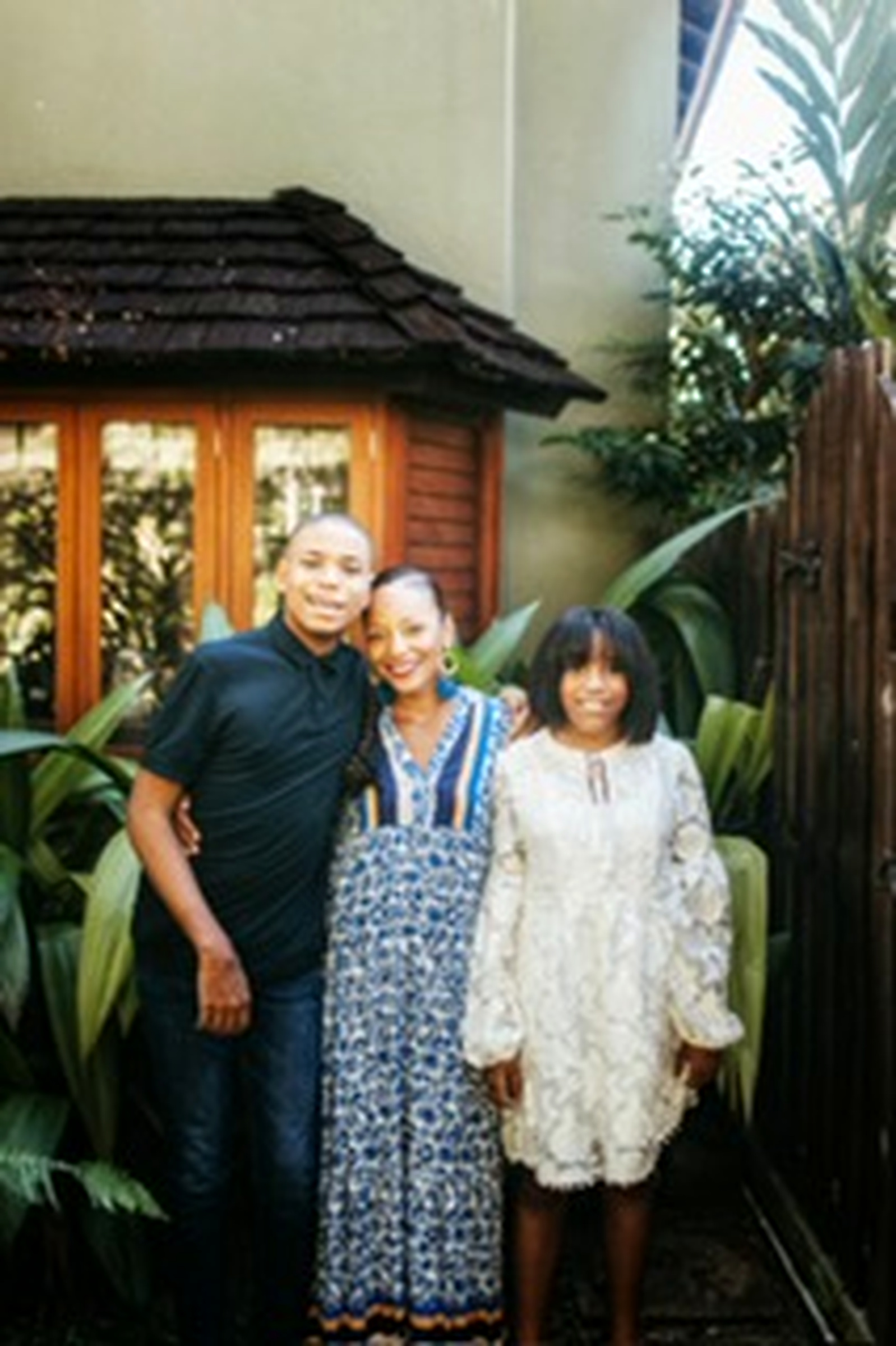 Francene Noel standing with her son and daughter in a garden