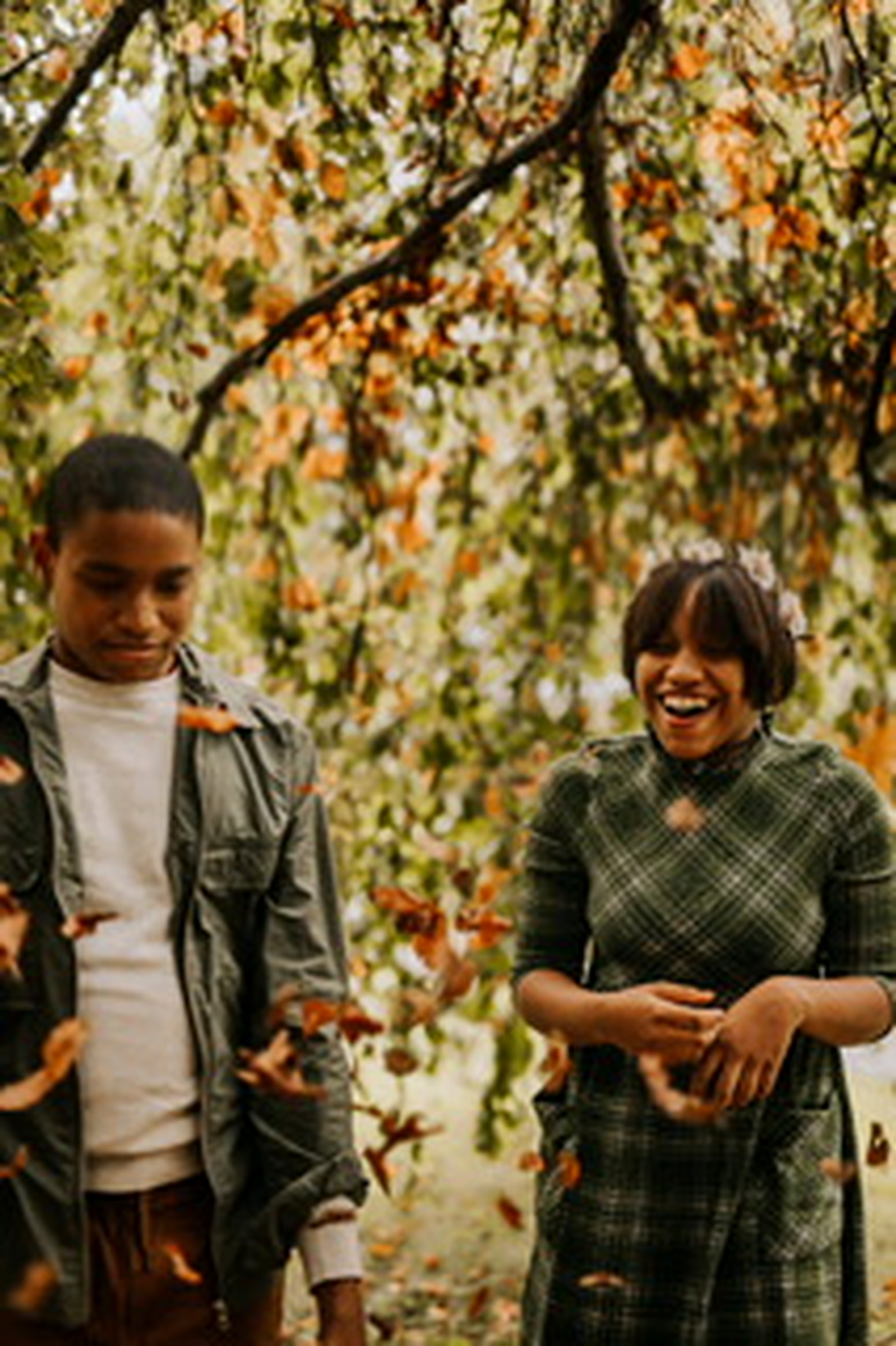 Francene Noel's children laughing together beneath autumn trees